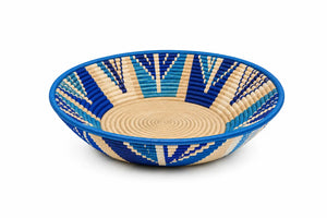 Hand-woven blue and cream geometric basket bowl made of sisal, perfect for wall decor or as a fruit bowl.