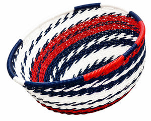 Round woven basket with a patriotic red, white, and blue striped spiral design for home decor.