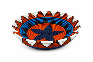 Hand-woven telephone wire basket featuring vibrant orange, blue, and white geometric patterns.