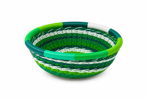 Decorative green and white woven telephone wire bowl with a concentric circular pattern on a white background.