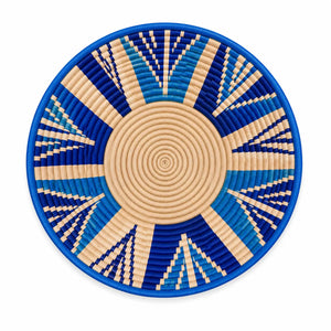 Handwoven blue and cream geometric sunburst wall basket, artisanal decorative bowl for boho home decor.